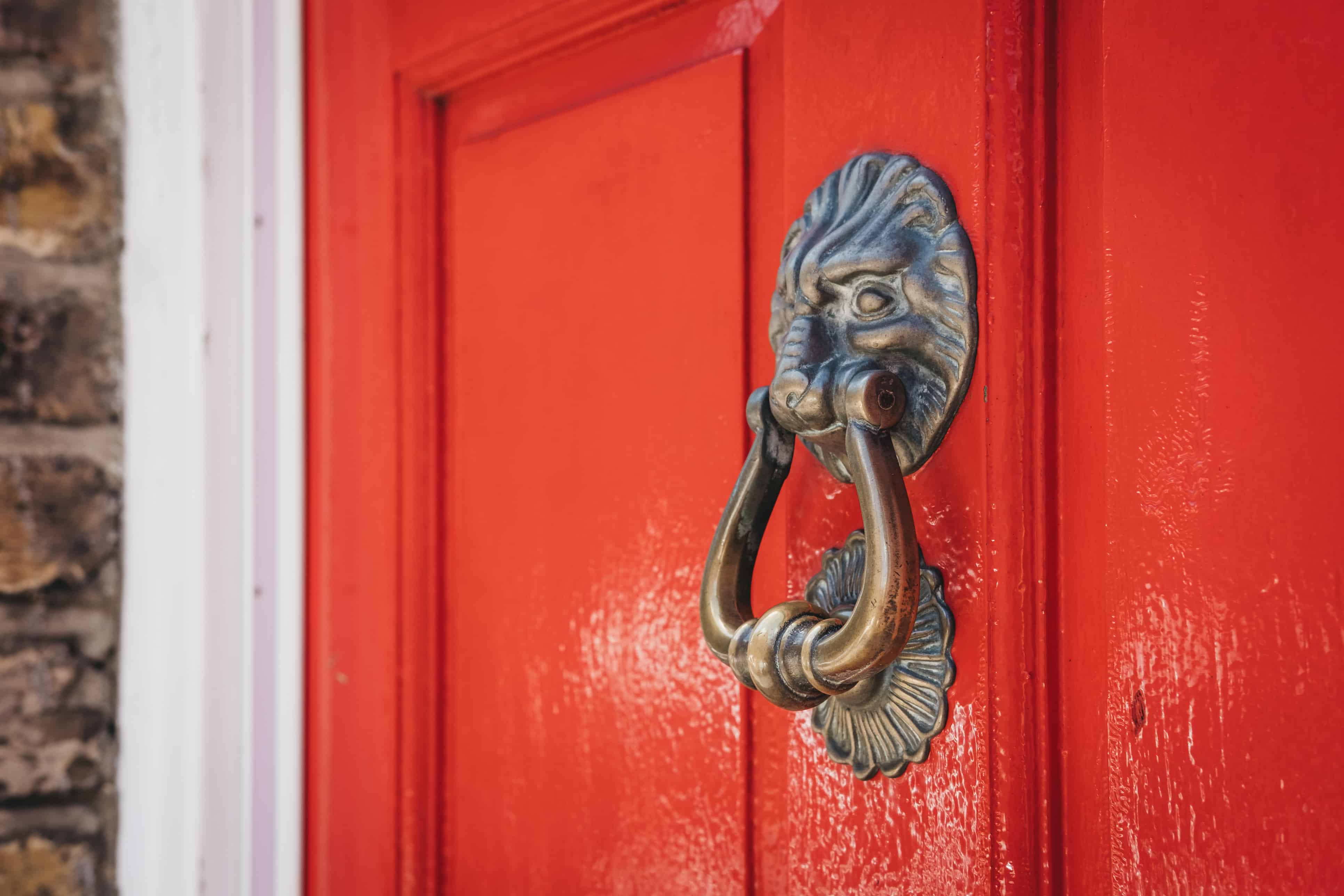 red door, brass knocker